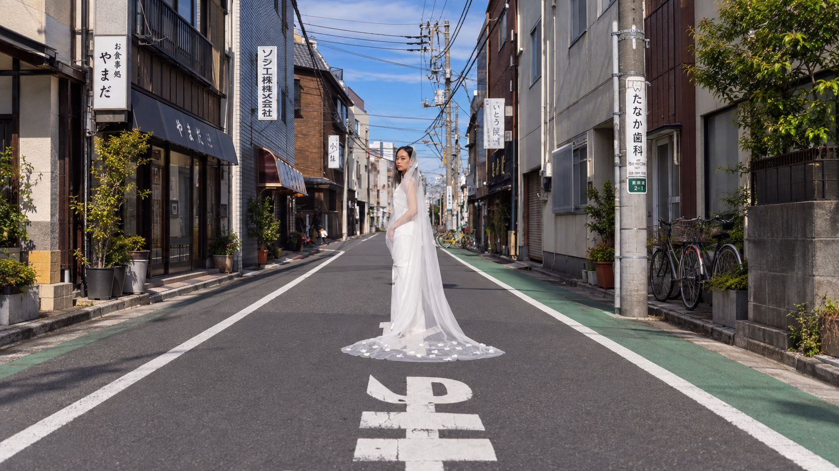 Bride standing in the middle of a Japanese street