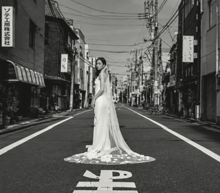 Bride standing in the middle of a Japanese street
